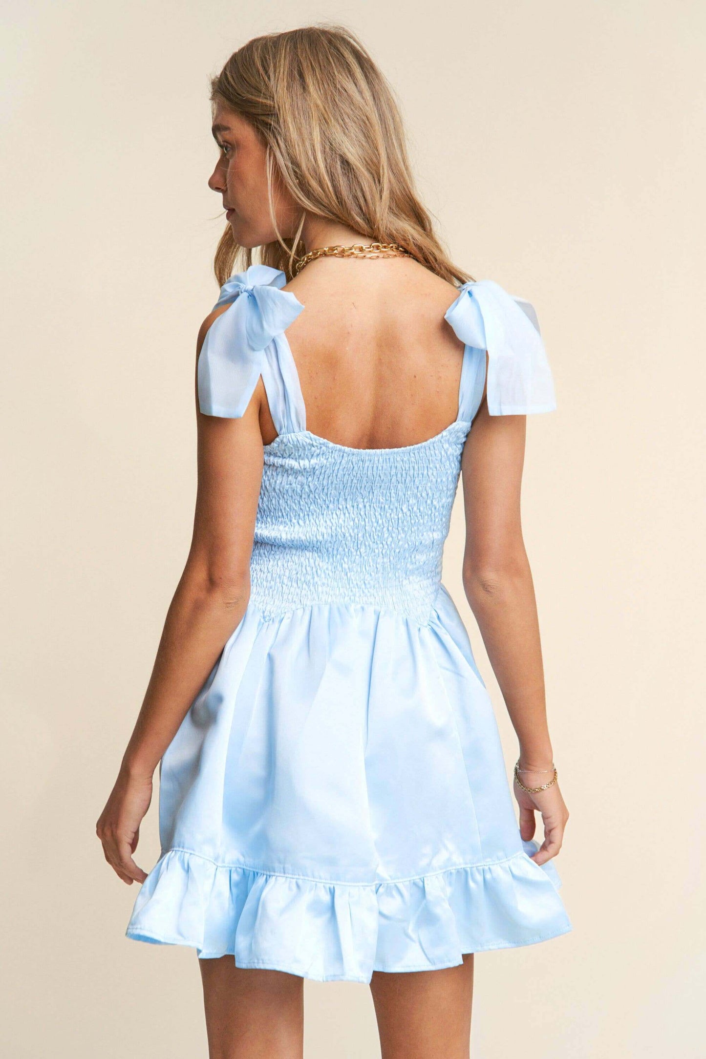 Light blue smocked mini dress with tiered ruffle hem and bow tie straps – sweet and elegant spring look