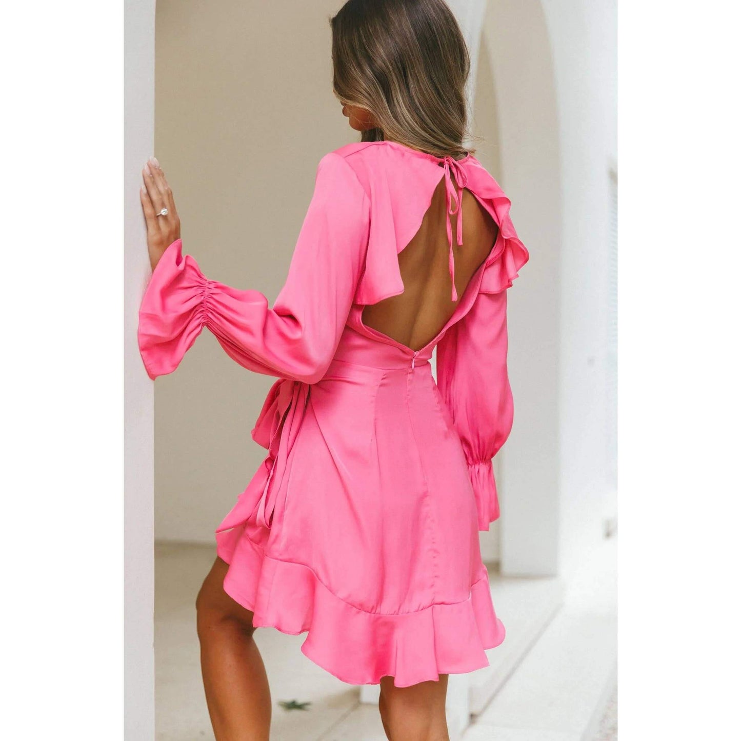 Hot pink satin wrap dress with long sleeves and ruffle hem – elegant and flirty cocktail dress for special occasions