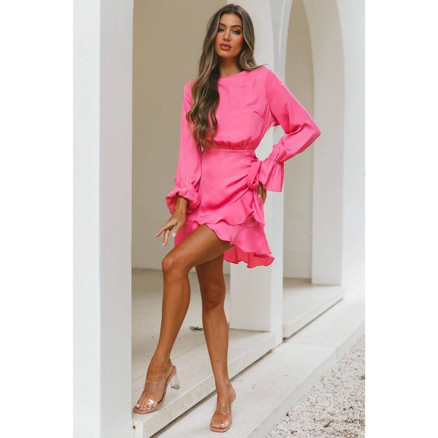 Hot pink satin wrap dress with long sleeves and ruffle hem – elegant and flirty cocktail dress for special occasions