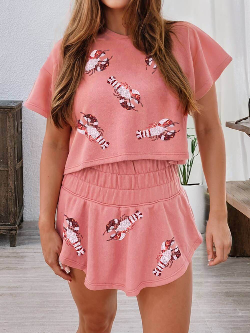 Pink and white loungewear set with crawfish sequin graphic crop top and matching elastic waist shorts – fun Southern-inspired outfit