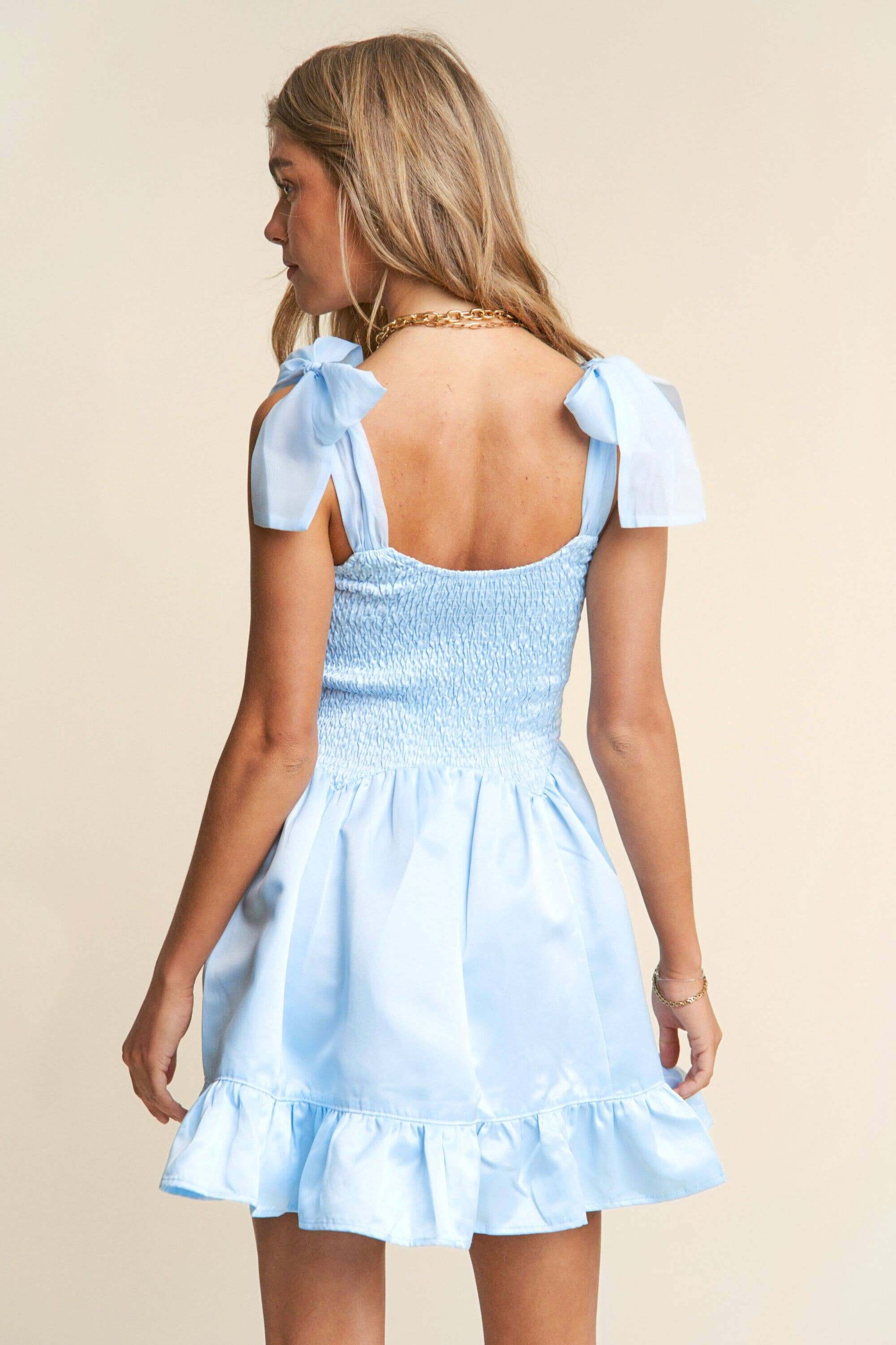 Light blue smocked mini dress with tiered ruffle hem and bow tie straps – sweet and elegant spring look
