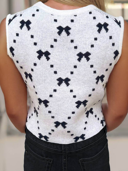 Ivory knit cropped sweater vest with bow pattern and side button details – sleeveless trendy layering top