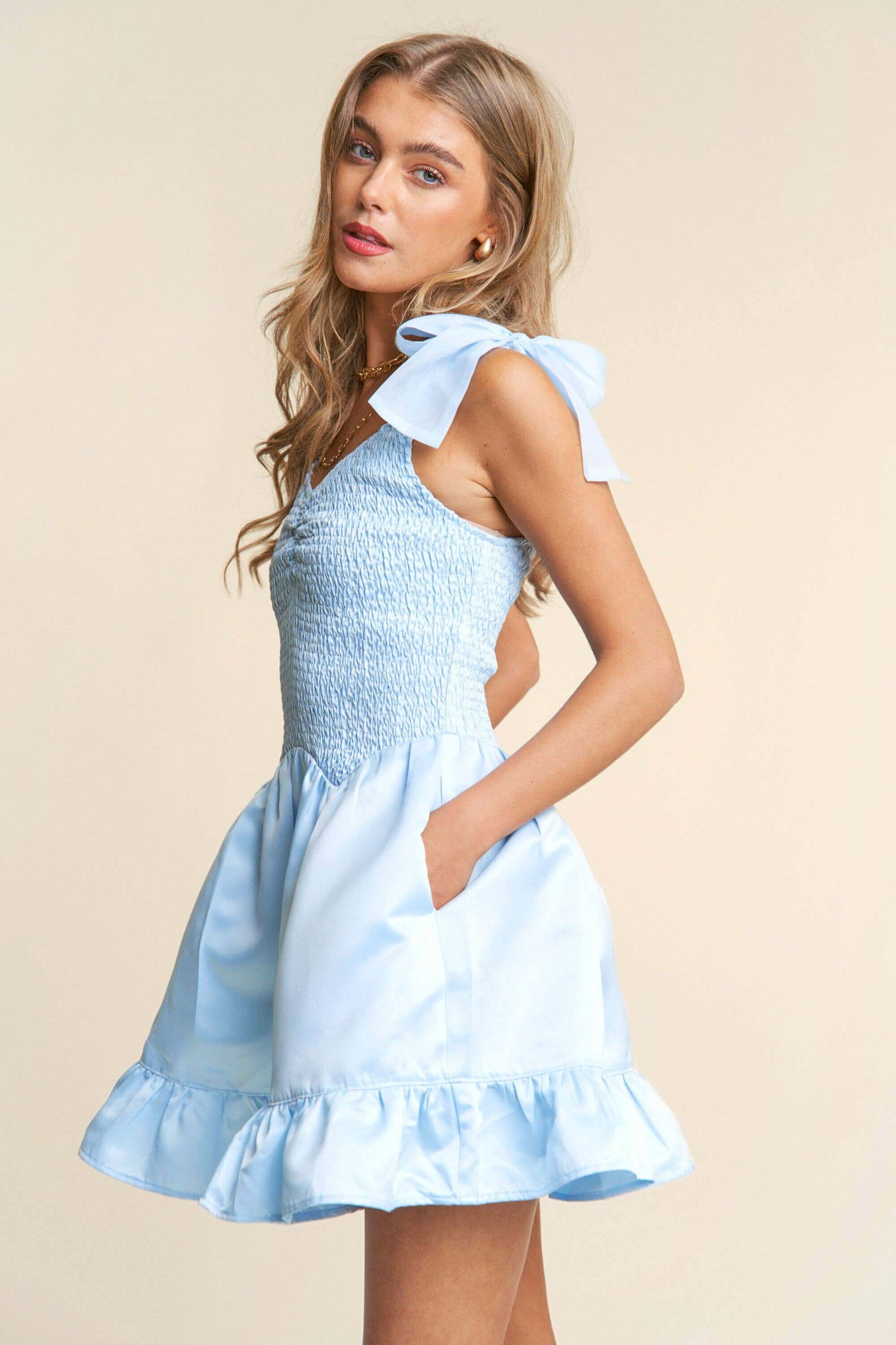 Light blue smocked mini dress with tiered ruffle hem and bow tie straps – sweet and elegant spring look